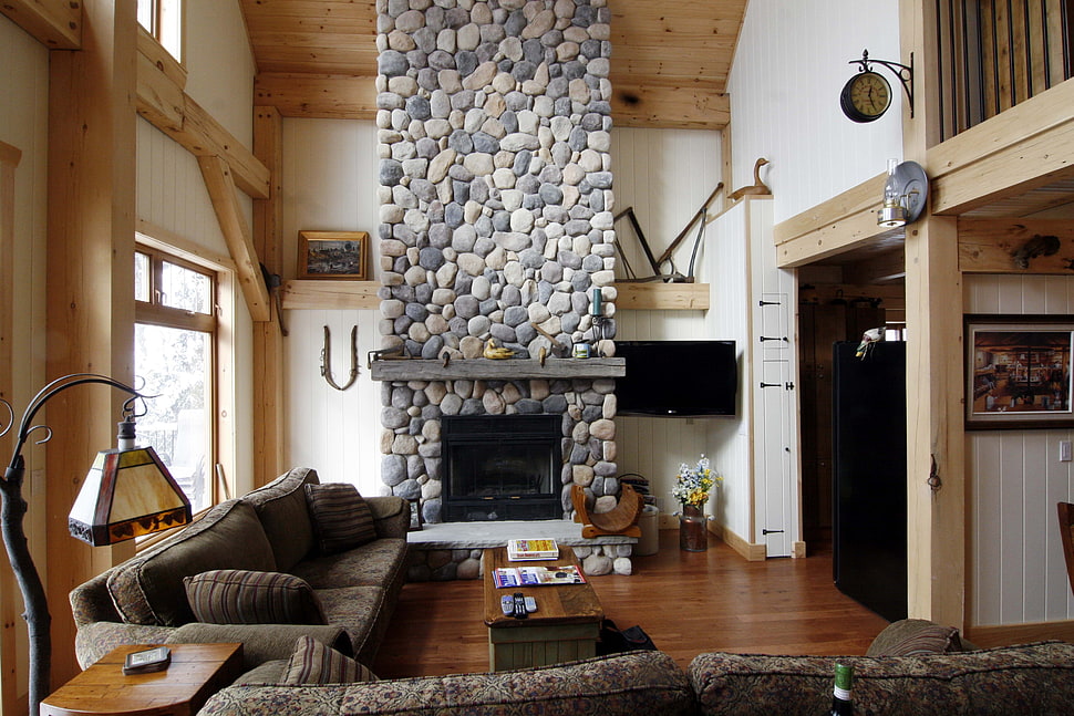 black suede 2-seat sofa beside brown concrete fireplace HD wallpaper